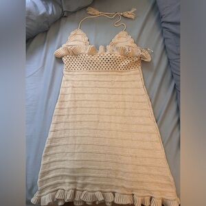 Small tan dress with tie top with cut out detail.